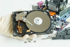 man holding failed hard drive in need of data recovery service in Brisbane